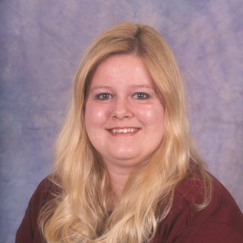 Smiling woman with blonde hair in a red sweater