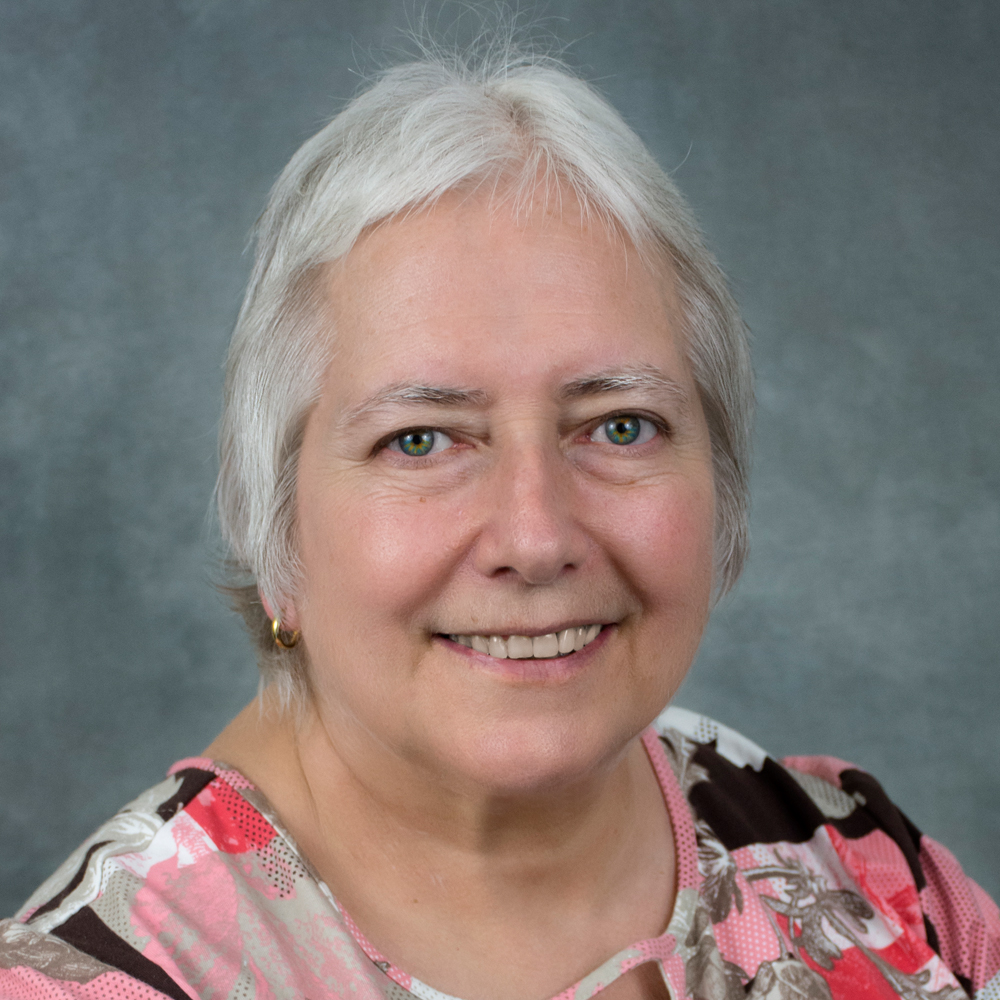 Smiling woman in a floral shirt