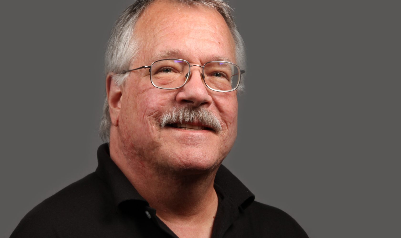 headshot of male wearing glasses