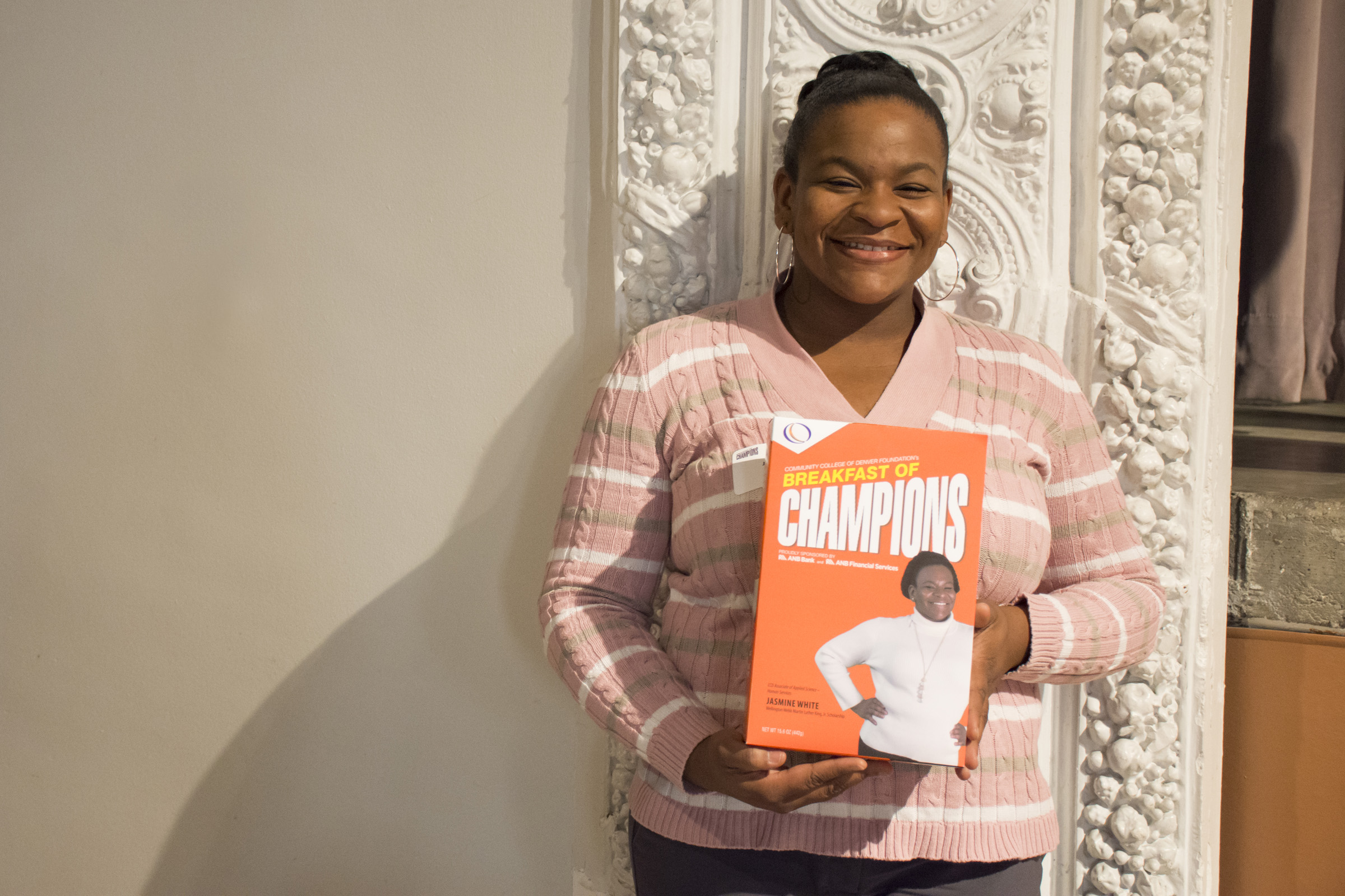 CCD Human Services Student Jasmine White woman holding a Breakfast of Champions cereal box