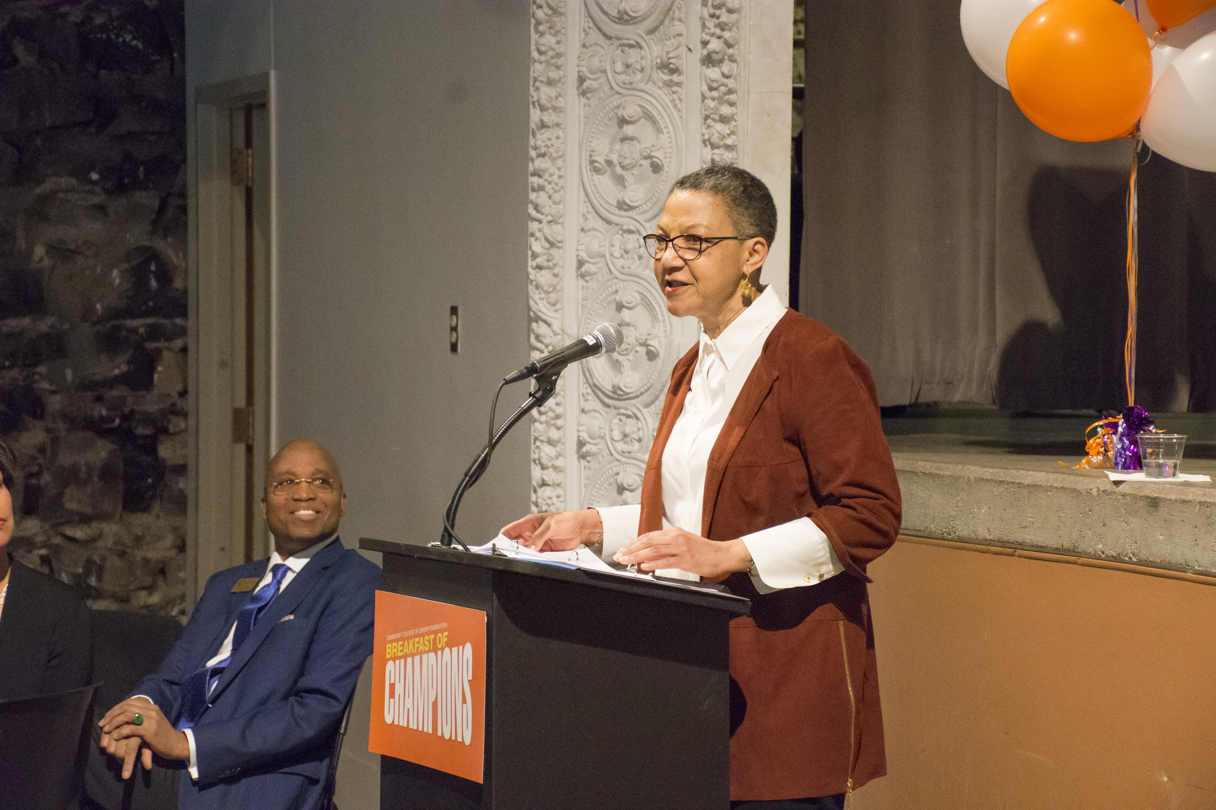 Dr. Everette Freeman, Keynote Speaker Lauren Casteel woman at a podium giving a speech