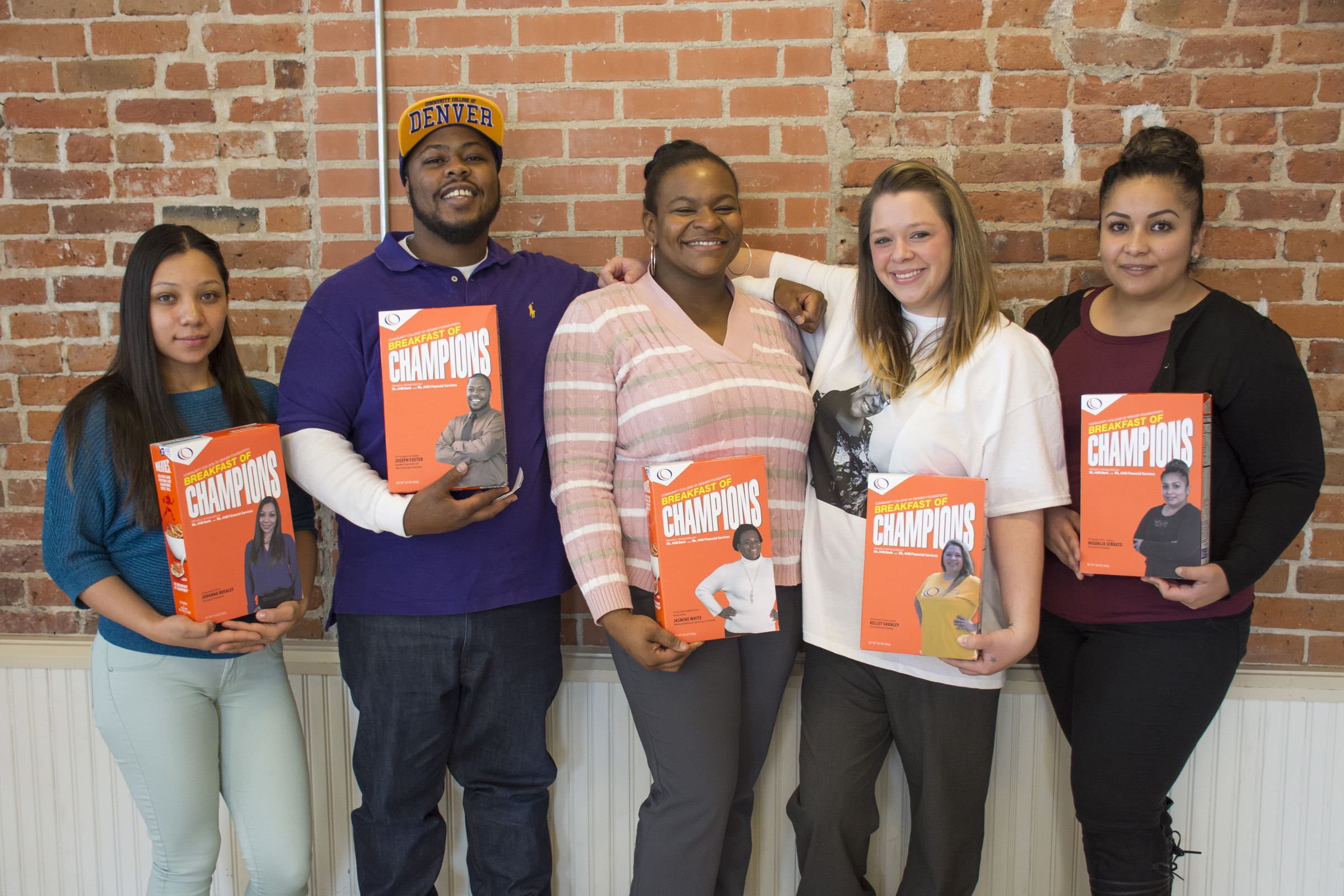 a group of students holding Breakfast of Champion cereal boxes