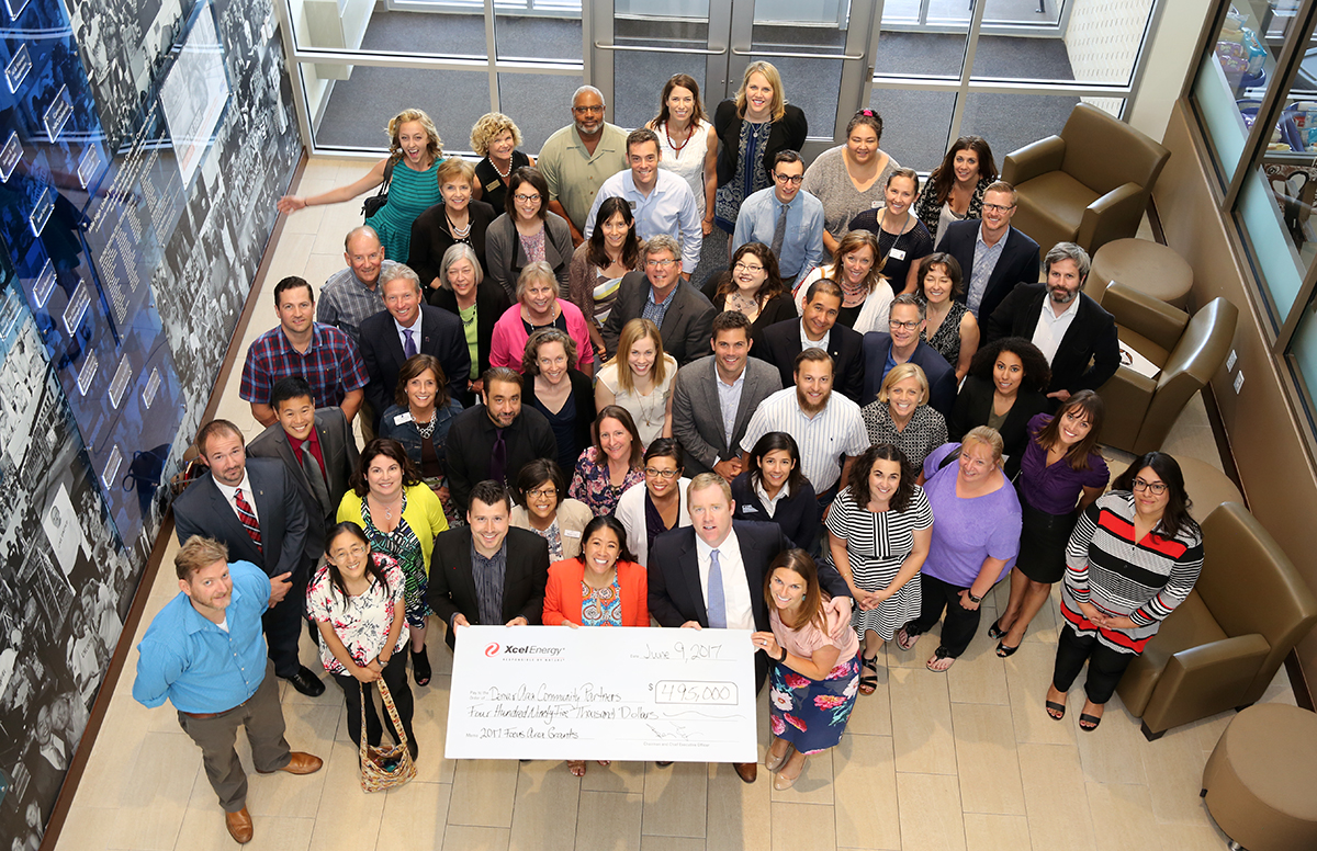 group of people holding large donation check