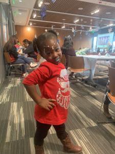 Child in red and brown boots