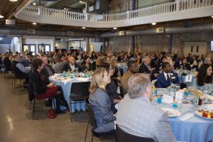 banquet tables with people eating at an event