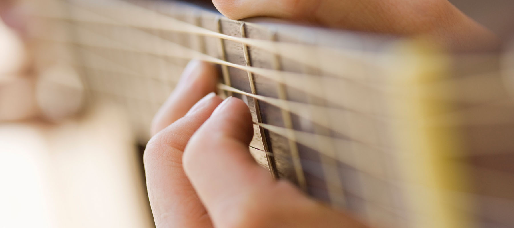 fingers strumming a guitar