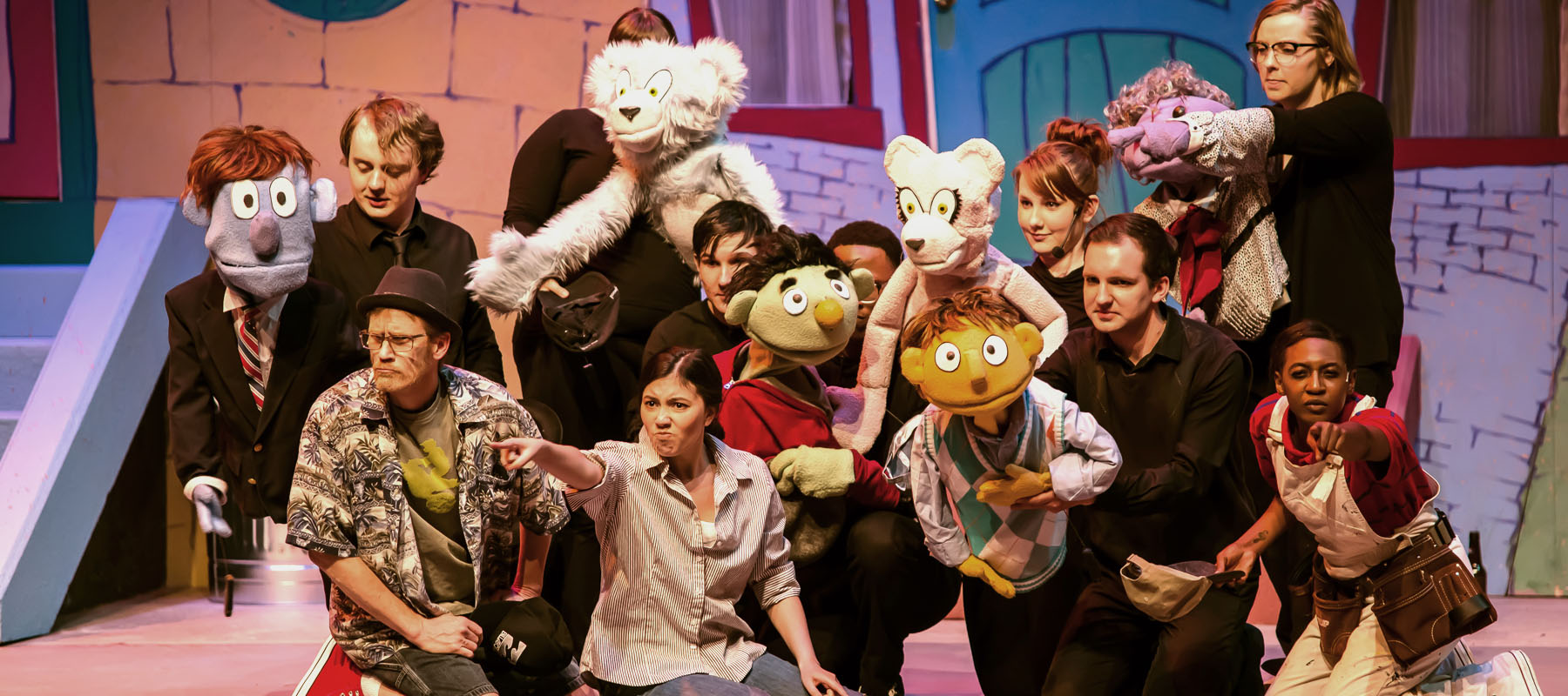 group on stage in a production with puppets