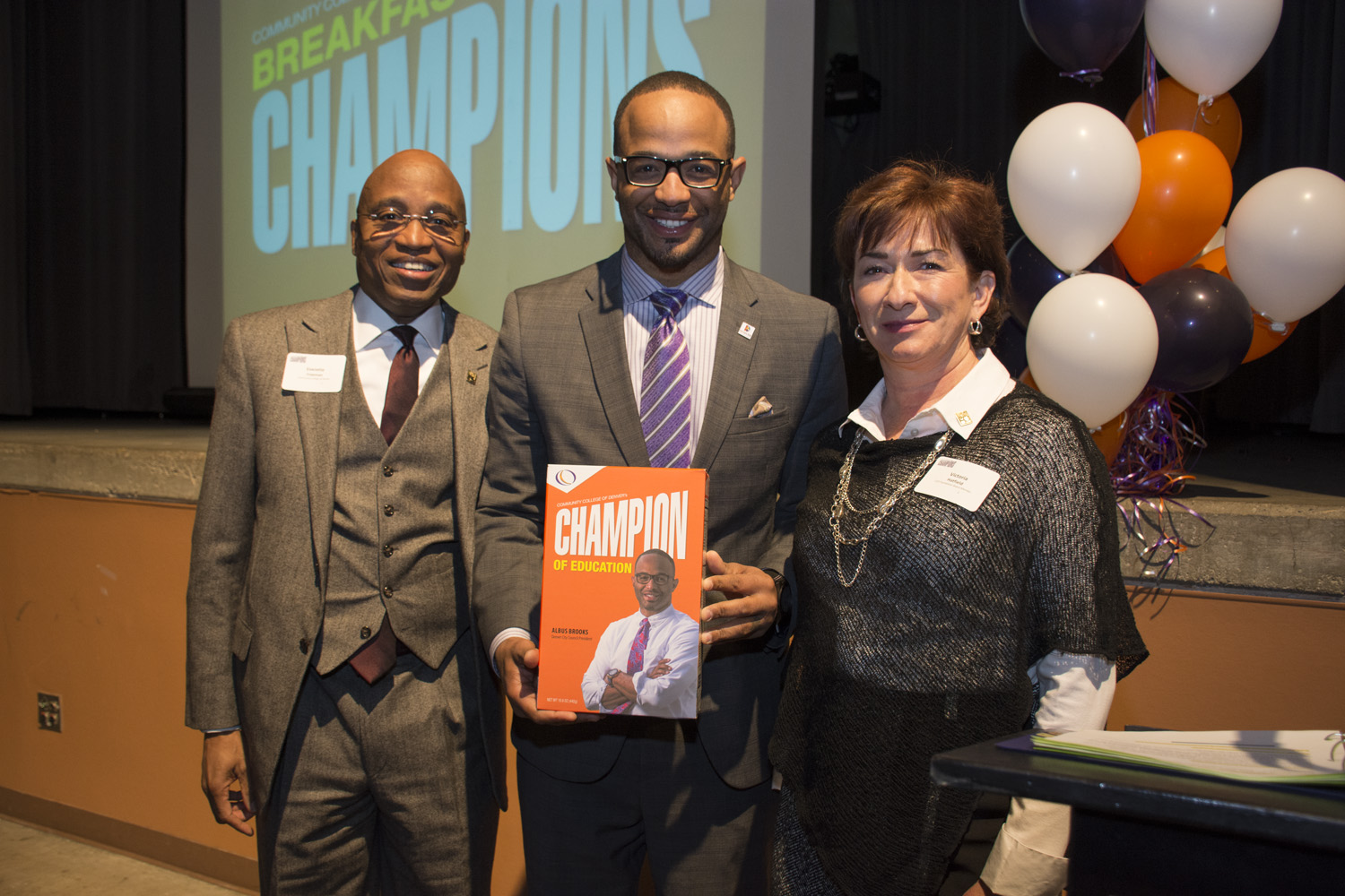 CCD President Everette Freeman, Councilman Albus Brooks and President of CCD’s Board of Directors, Victoria Hatfield two men and a women pose at an awards celebration