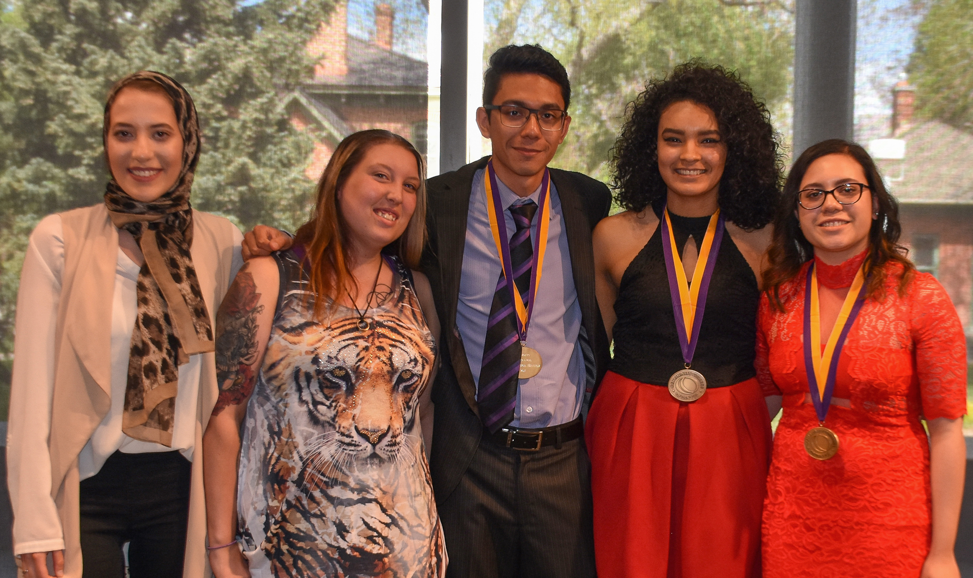 five students wearing medals around their necks