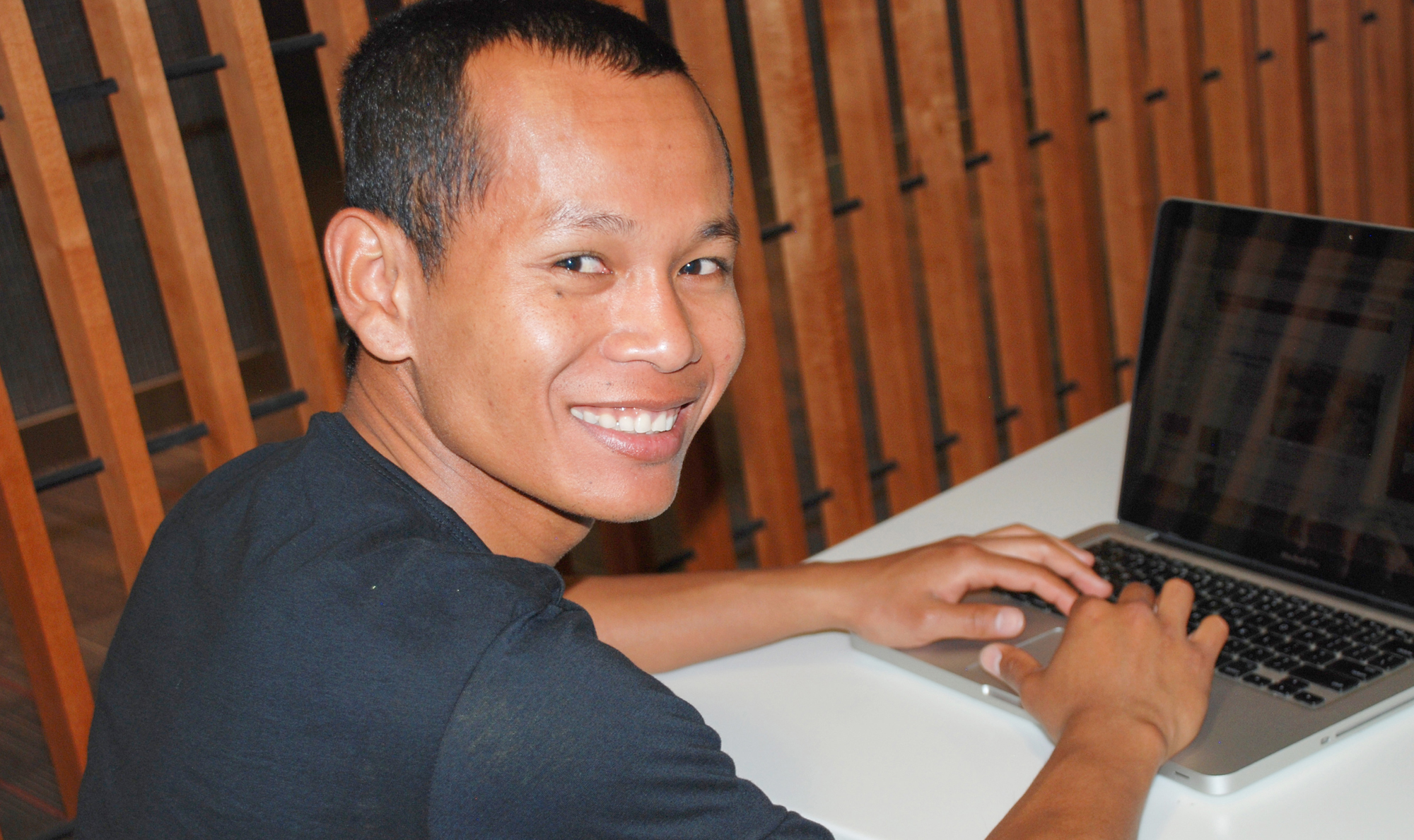 male student with a lap top computer