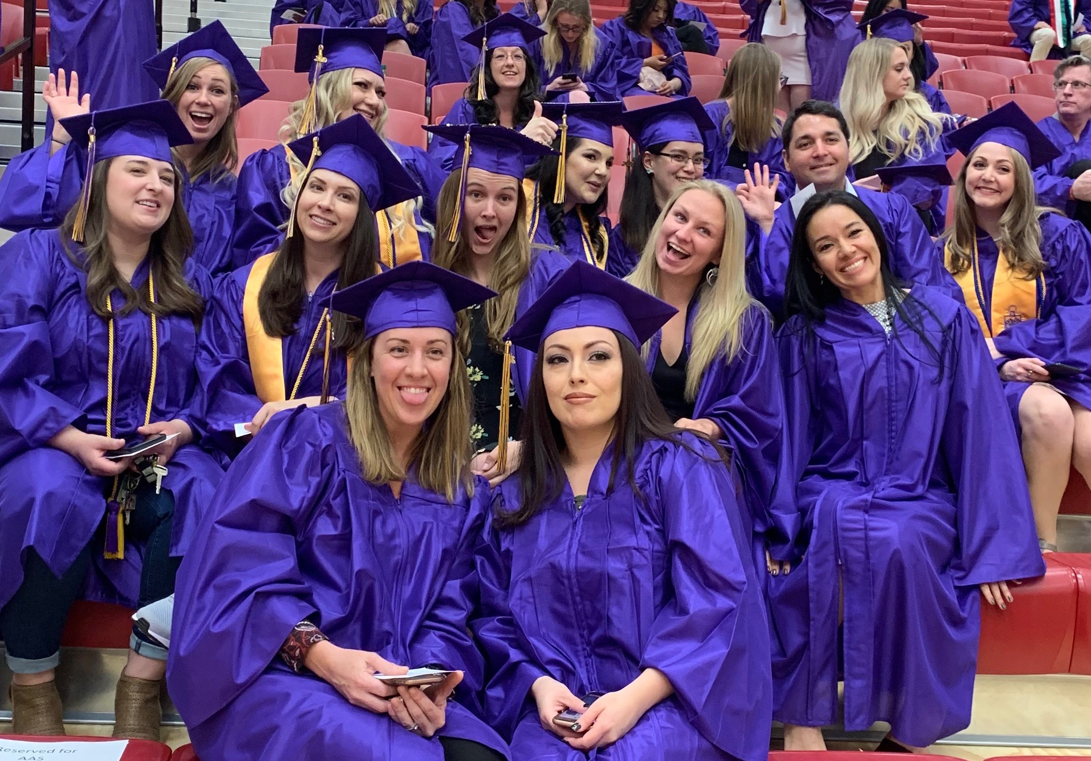 Women waiting to walk out for graduation dressed in purple