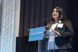 woman speaks from a podium