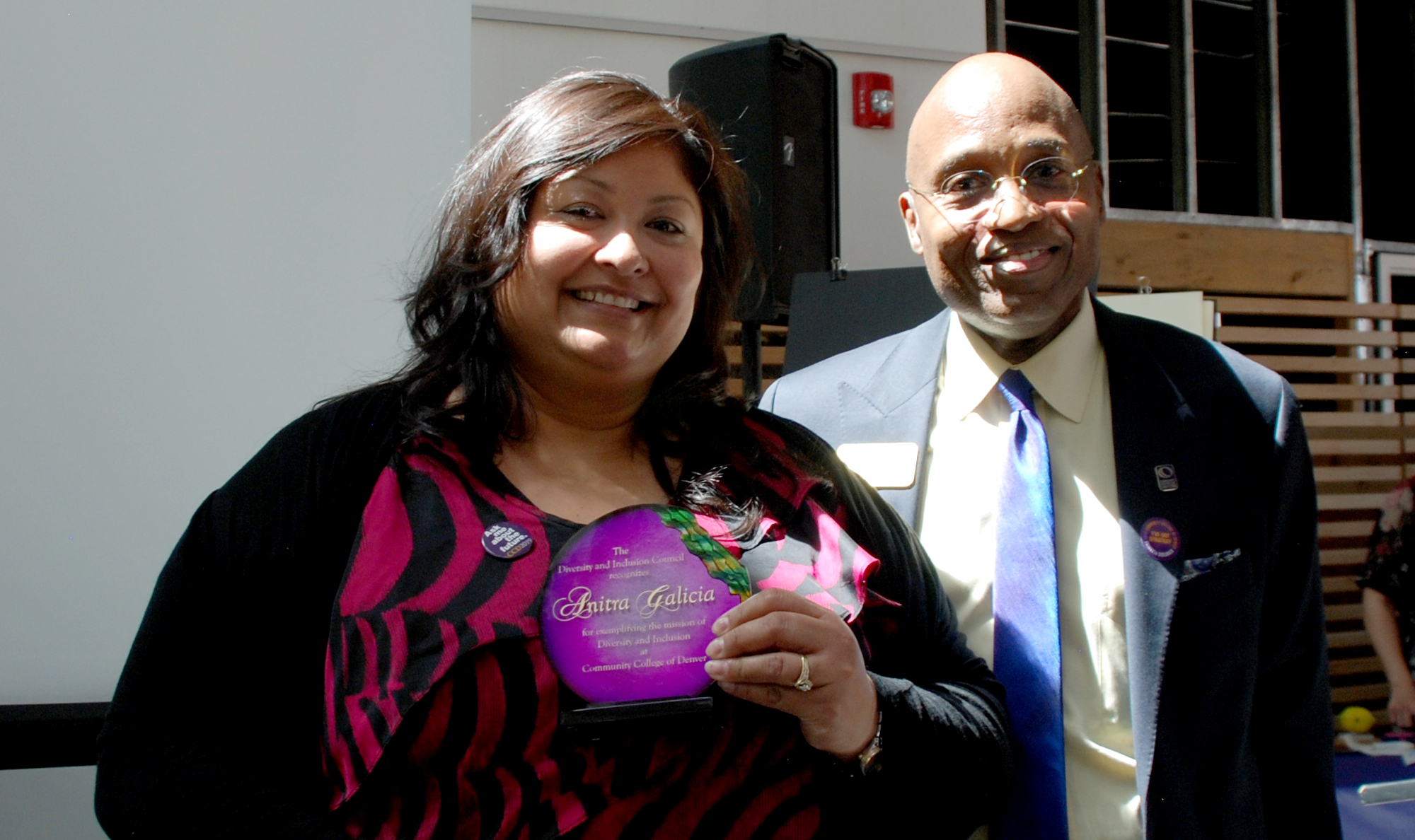 CCD 2014 Diversity Award Winner Anitra Galicia with the College president Everette Freeman Woman holding a certificate poses next to man in suit