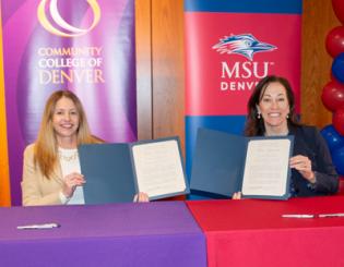 Dr. Marilena DeSanctis and Dr. Janine Davidson holding up signed documents.