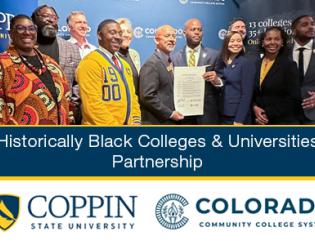 Group of men and women posing with a document in hand.