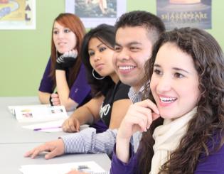 Four CCD students smiling at professor
