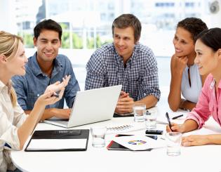 image of a group of five adults looking at graphs and talking
