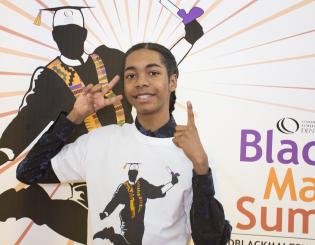 young black male standing smiling