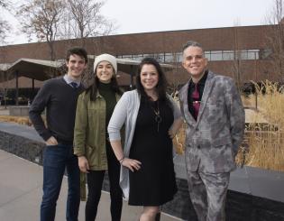 3 college students and an instructor standing outside smiling