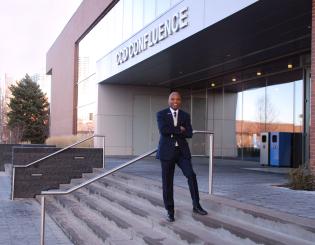 a man standing on the steps in front of a building