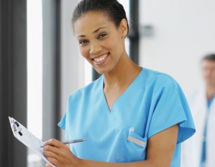 image of a young nurse wearing medical scrubs holding a clipboard