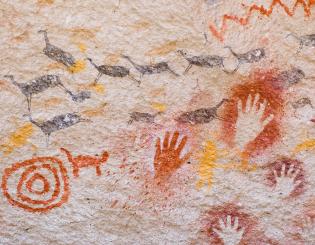 Ancient cave paintings of hands and animals