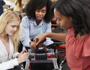 Robotics students working with their professor