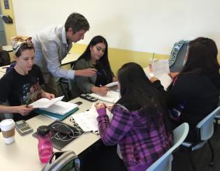 a teacher helping 4 female students