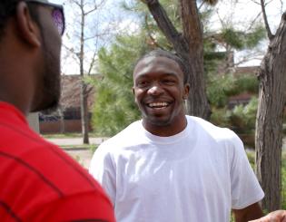 Three male CCD students laughing in the Cherry Creek Courtyard