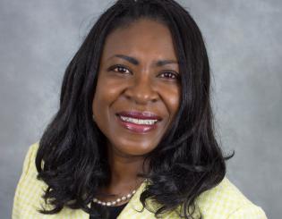 Smiling woman in a yellow suit jacket