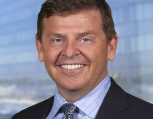 white man in a suit smiling