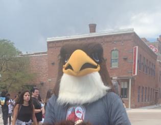 CCD Mascot Swoop in from of Tivoli Student Union in a grey shirt