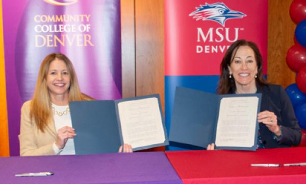Dr. Marilena DeSanctis and Dr. Janine Davidson holding up signed documents.