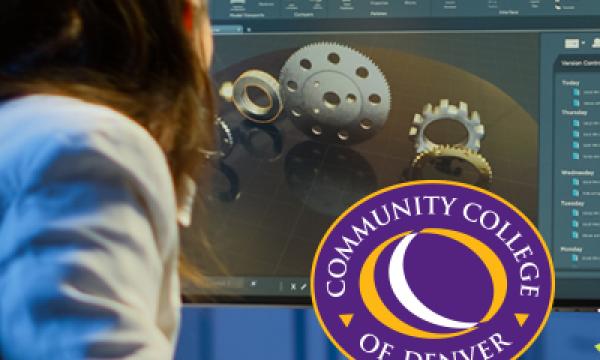 Person with brown shoulder length wearing a blue shirt looking at a computer screen. Community College of Denver logo