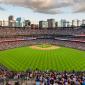 Image of Coors field on a summer day with clouds, fans, and a baseball field