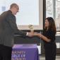 Interim President of CCD handing award to team member 