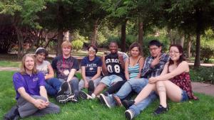 Summer Bridge students sit in the grass.
