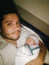 man with newborn baby
