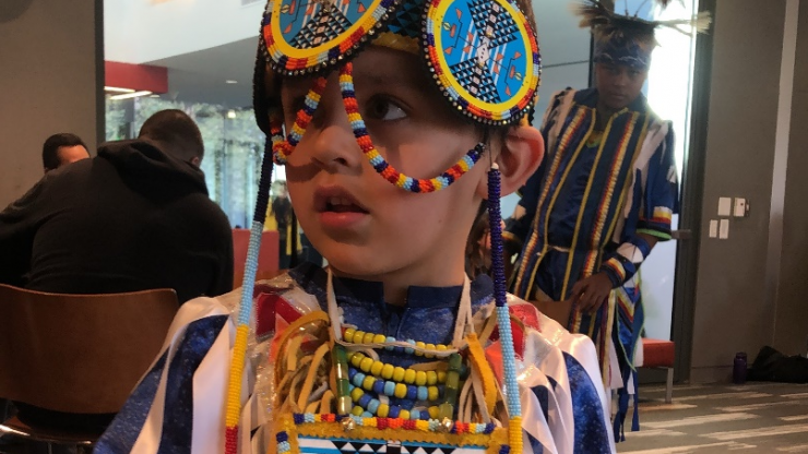 young boy dressed in colorful traditional native wear