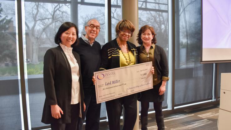 board members presenting a large check to a professor