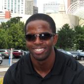 young man with sunglasses smiles at the camera
