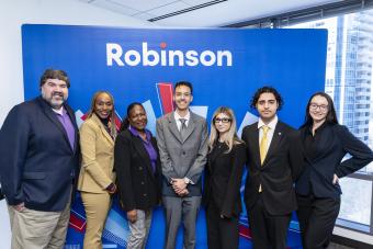 Community College of Denver (CCD) faculty members posing with four students dressed in suits. 