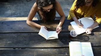 students reading at a table