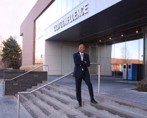 a man standing on the steps in front of a building
