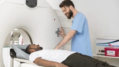 man in scrubs giving man a c-scan
