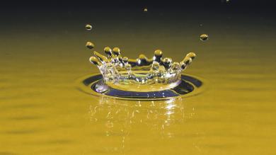 Water droplet in pool of still water