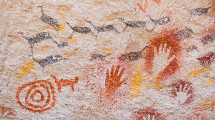 Ancient cave paintings of hands and animals