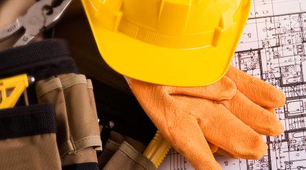 yellow hard hat, work clothes and blue prints