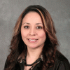 Woman with waving hair wearing a black shirt.