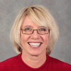 Smiling woman with glasses in a red shirt